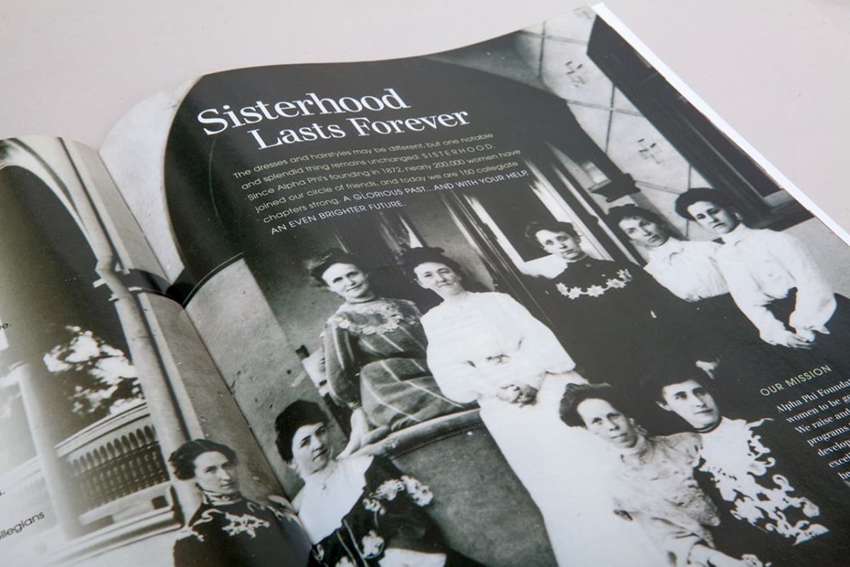 an open copy of the quarterly showing an old black and white photo of a sorority
